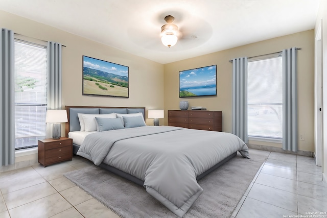 tiled bedroom featuring ceiling fan