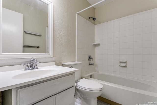 full bathroom with vanity, toilet, and tiled shower / bath combo