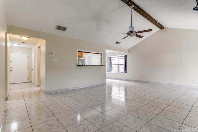 unfurnished living room with ceiling fan, vaulted ceiling with beams, light tile patterned floors, and a textured ceiling