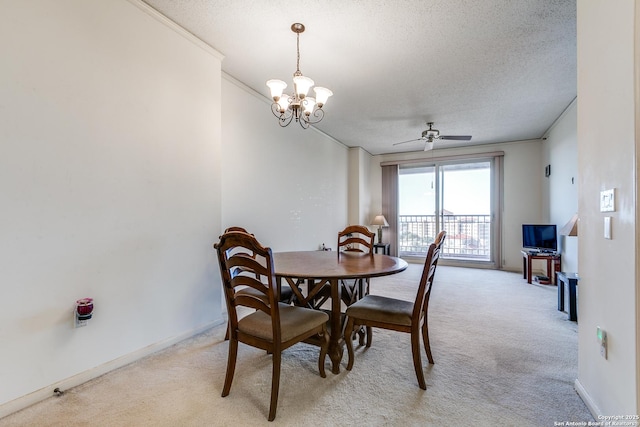 dining space with light colored carpet, ornamental molding, ceiling fan with notable chandelier, and a textured ceiling