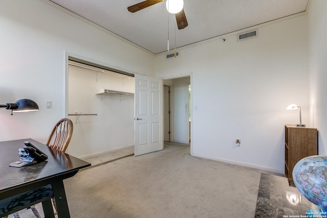 carpeted home office with ceiling fan