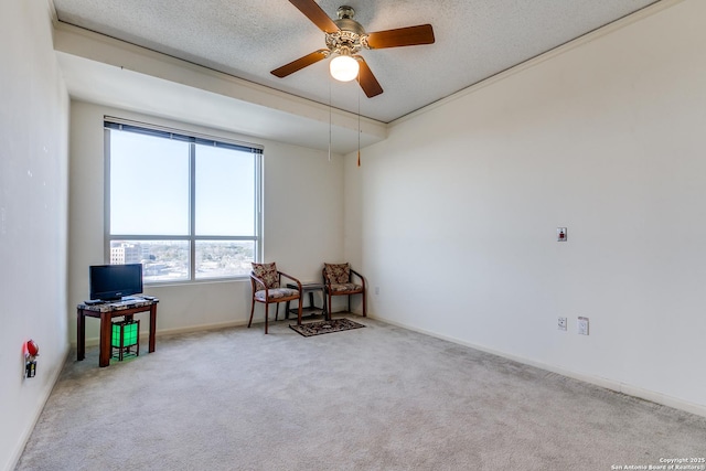 interior space with light carpet, ceiling fan, and a textured ceiling