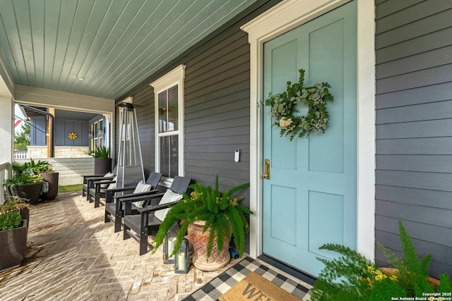 view of exterior entry featuring a porch