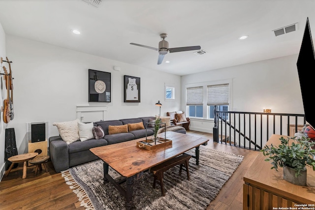 living room featuring hardwood / wood-style floors and ceiling fan