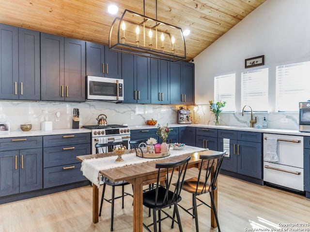 kitchen with pendant lighting, wood ceiling, high end range, blue cabinets, and light wood-type flooring