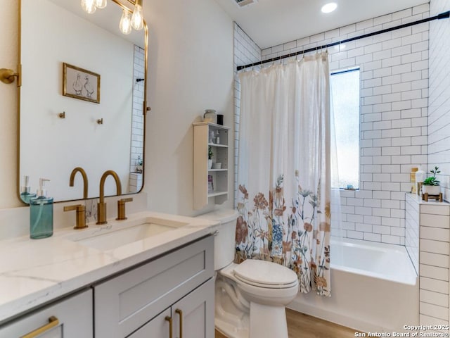 full bathroom with vanity, toilet, shower / tub combo, and hardwood / wood-style floors