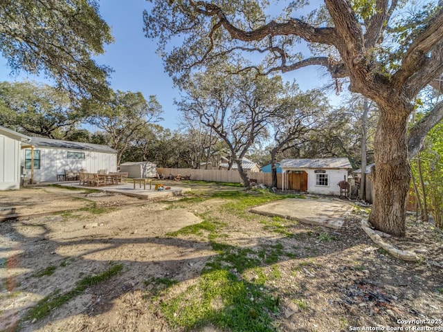 view of yard with a patio and a storage shed