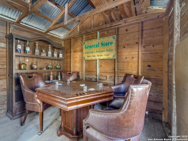 interior space with lofted ceiling and wood walls