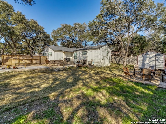 view of yard with a storage shed and a patio area