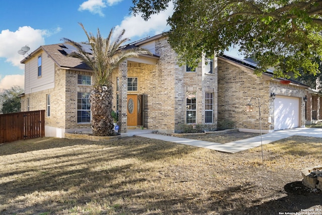 view of property with a garage and a front lawn