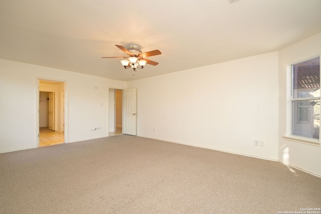 empty room with light colored carpet and ceiling fan