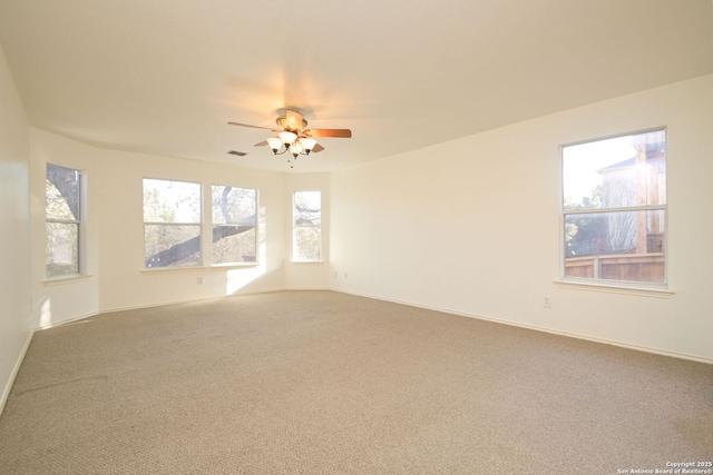 carpeted empty room featuring ceiling fan