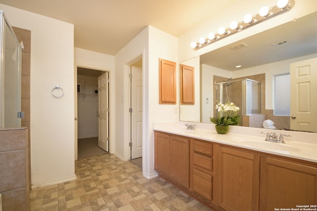 bathroom featuring vanity and a shower with shower door