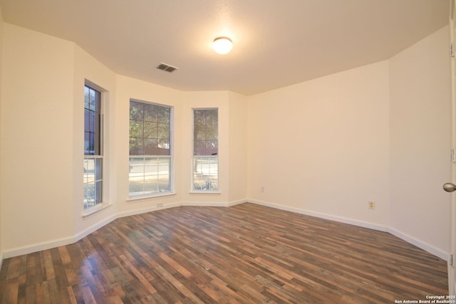 empty room with dark hardwood / wood-style floors