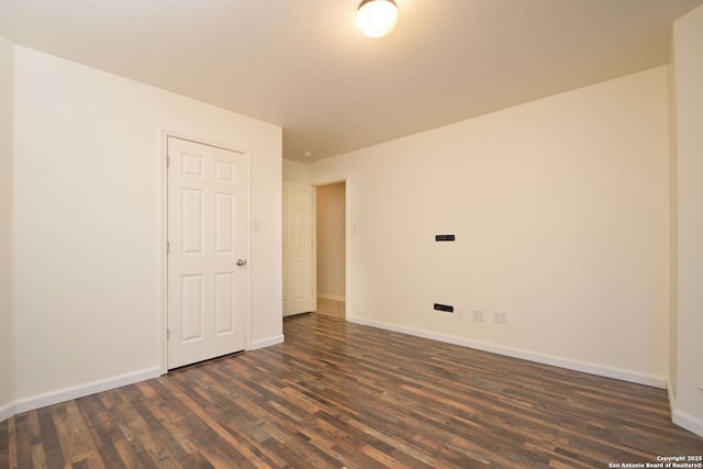 spare room featuring dark hardwood / wood-style floors