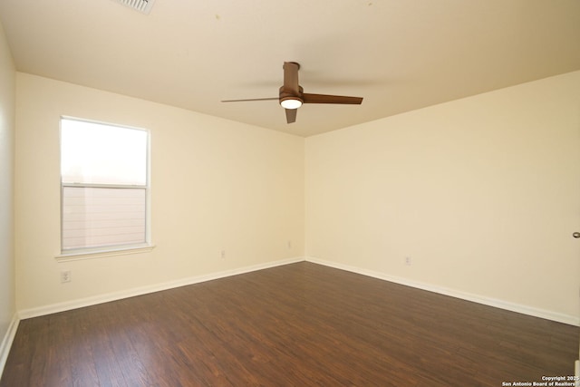 empty room with dark wood-type flooring and ceiling fan