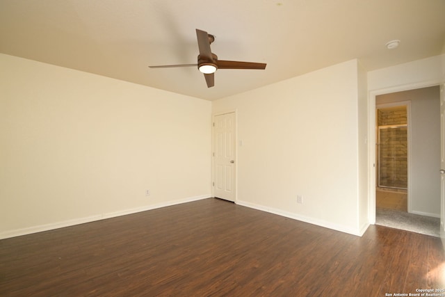 spare room with dark hardwood / wood-style floors and ceiling fan