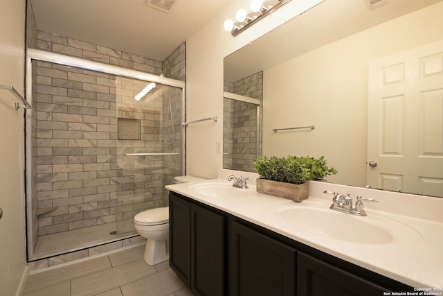 bathroom with vanity, toilet, and an enclosed shower