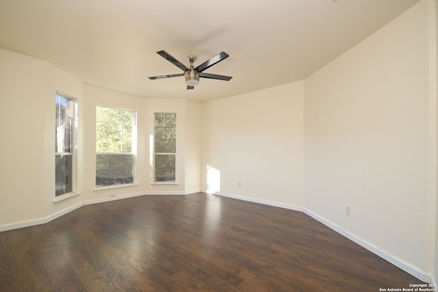 empty room featuring dark wood-type flooring and ceiling fan