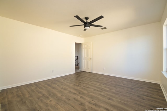 unfurnished room with ceiling fan and dark hardwood / wood-style flooring