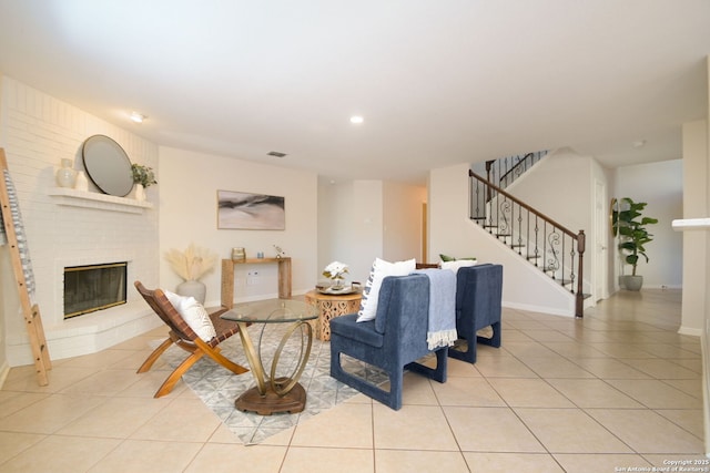 tiled living room featuring a fireplace