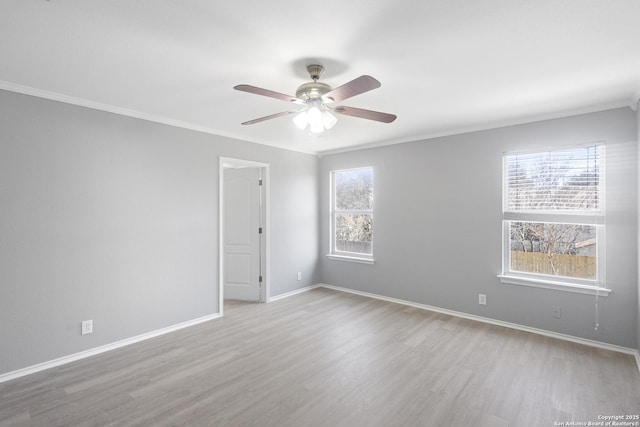 spare room with ornamental molding, light hardwood / wood-style floors, and ceiling fan