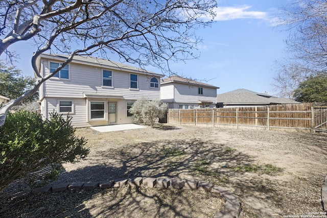 back of property with a patio