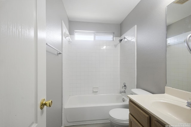 full bathroom with vanity, tiled shower / bath, and toilet