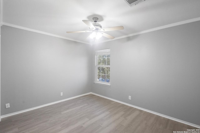 spare room featuring crown molding, wood-type flooring, and ceiling fan