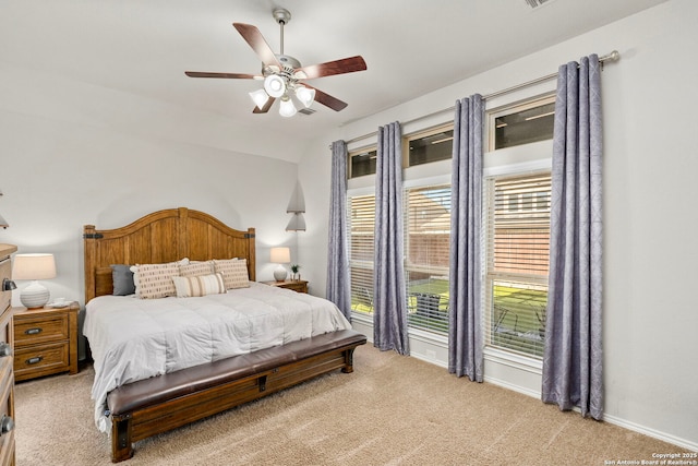 bedroom with vaulted ceiling, light carpet, and ceiling fan