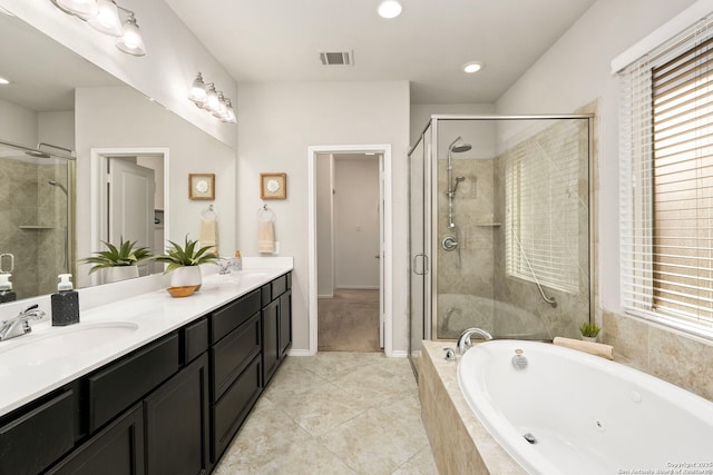 bathroom with tile patterned flooring, plus walk in shower, a healthy amount of sunlight, and vanity