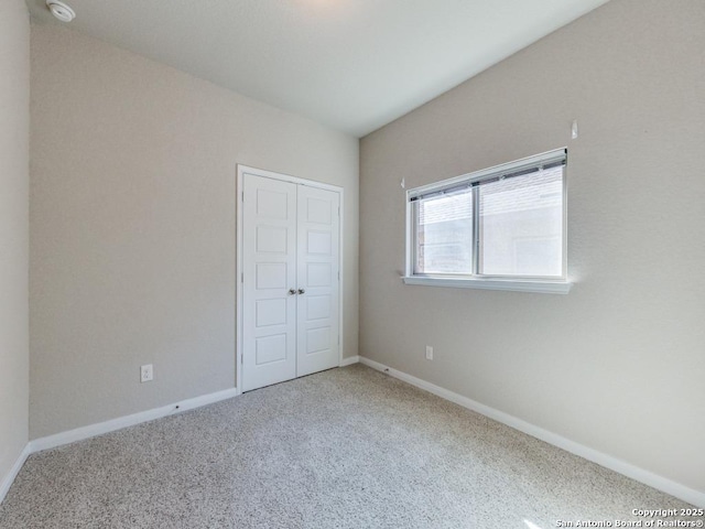 unfurnished bedroom featuring carpet floors and a closet