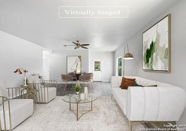 living room featuring ceiling fan and light wood-type flooring