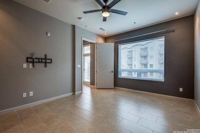 empty room featuring light tile patterned flooring and ceiling fan