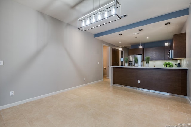 kitchen featuring dark brown cabinetry, stainless steel fridge with ice dispenser, and decorative light fixtures