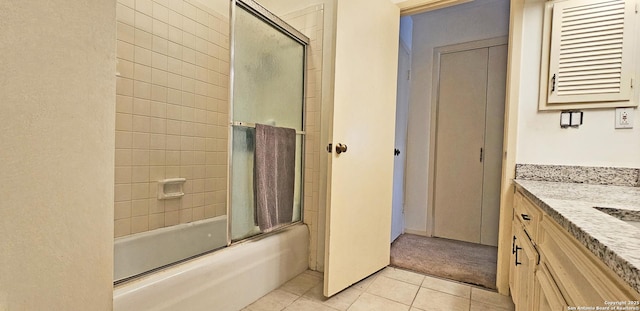 bathroom featuring tile patterned floors, combined bath / shower with glass door, and vanity