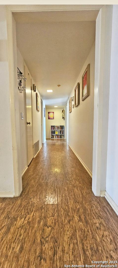 corridor featuring hardwood / wood-style floors