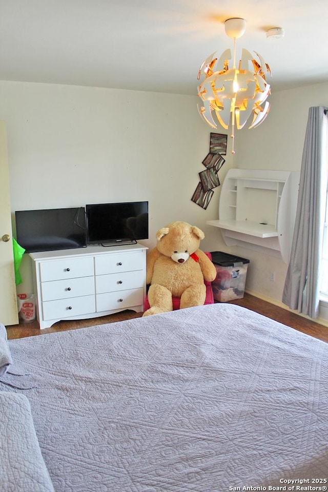 bedroom featuring an inviting chandelier