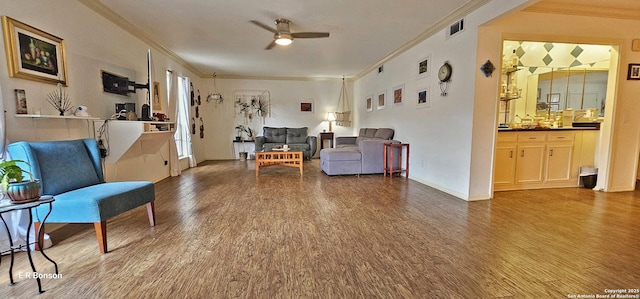 sitting room with hardwood / wood-style floors, ornamental molding, and ceiling fan