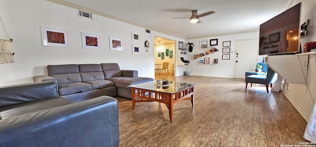 living room featuring crown molding, hardwood / wood-style floors, and ceiling fan