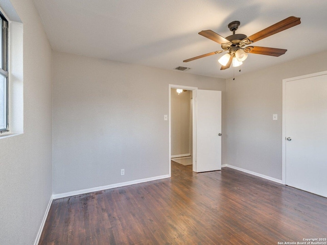 spare room with ceiling fan and dark hardwood / wood-style floors