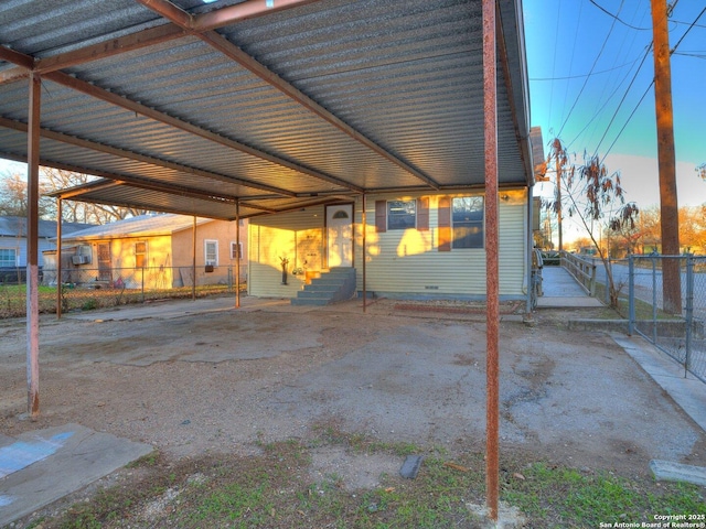 patio terrace at dusk featuring a carport