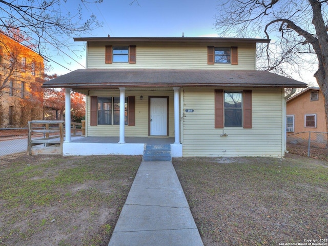 view of front of home featuring a front lawn and covered porch