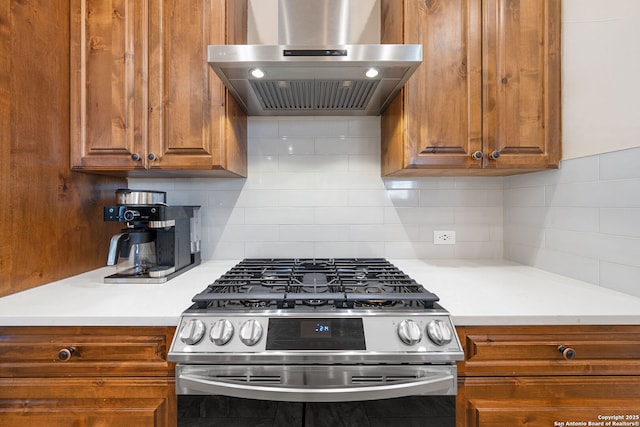 kitchen featuring stainless steel range with gas cooktop, exhaust hood, and decorative backsplash