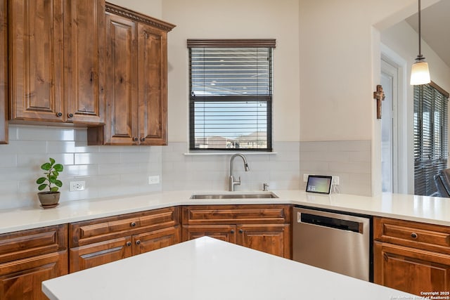 kitchen featuring sink, decorative light fixtures, a wealth of natural light, and dishwasher