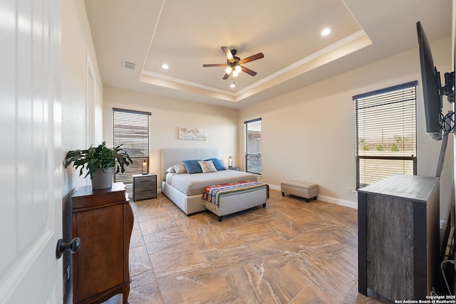 bedroom with a tray ceiling, ornamental molding, and ceiling fan