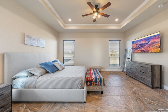 bedroom featuring ornamental molding, a raised ceiling, and ceiling fan