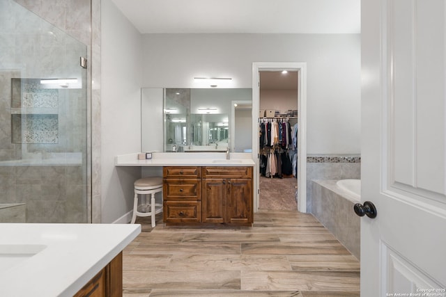 bathroom featuring vanity and separate shower and tub