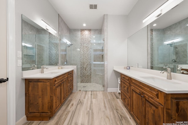 bathroom with vanity, hardwood / wood-style floors, and an enclosed shower