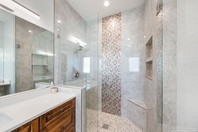 bathroom with vanity and tiled shower